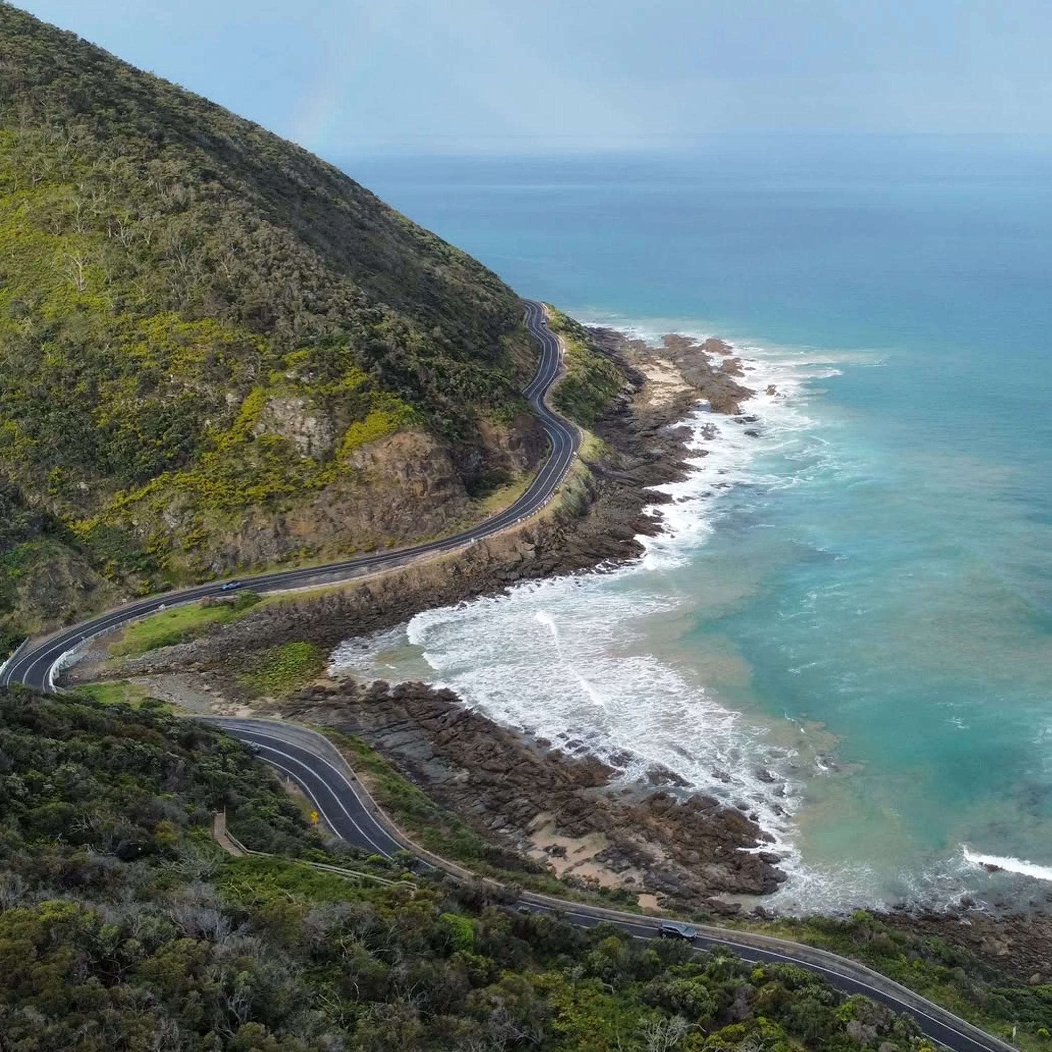 winding coastal road beside ocean
